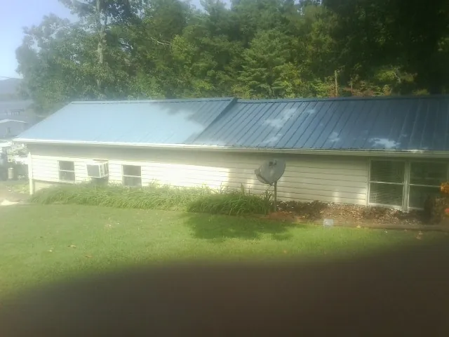 Blue metal roof running the length of a single story home in Hewitt
